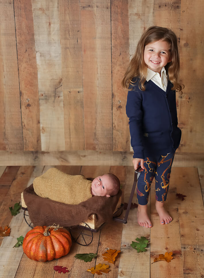 Big sister posed with baby brother