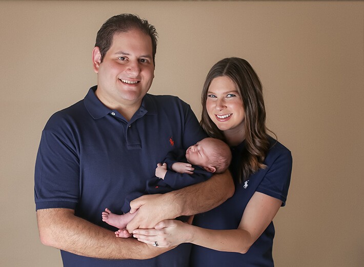 Parents holding baby boy