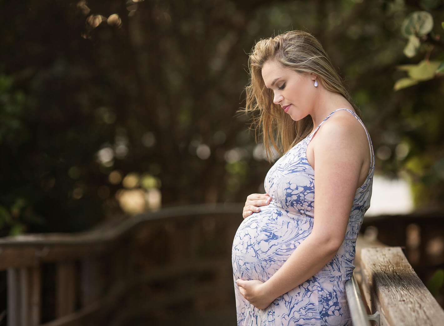 Mom-to-be looking down at her belly during maternity session
