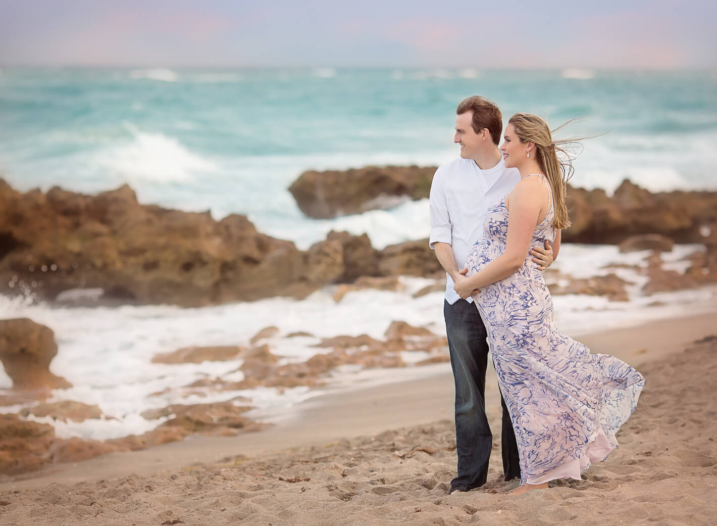 Maternity shoot on Jupiter Beach with rocks in the background