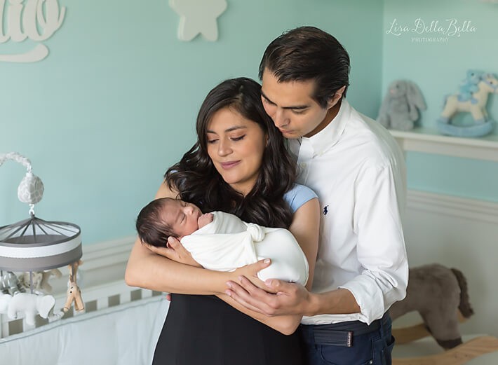 Mom and dad with baby in nursery