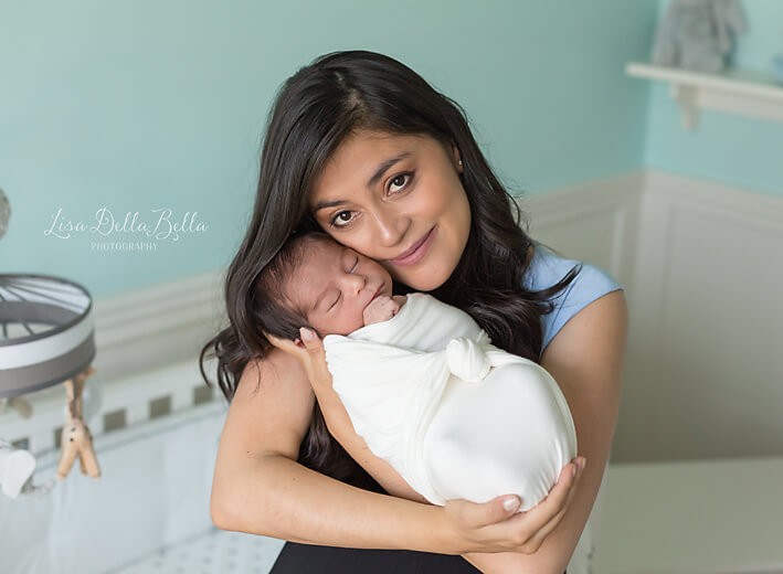 Mom and baby pose in nursery