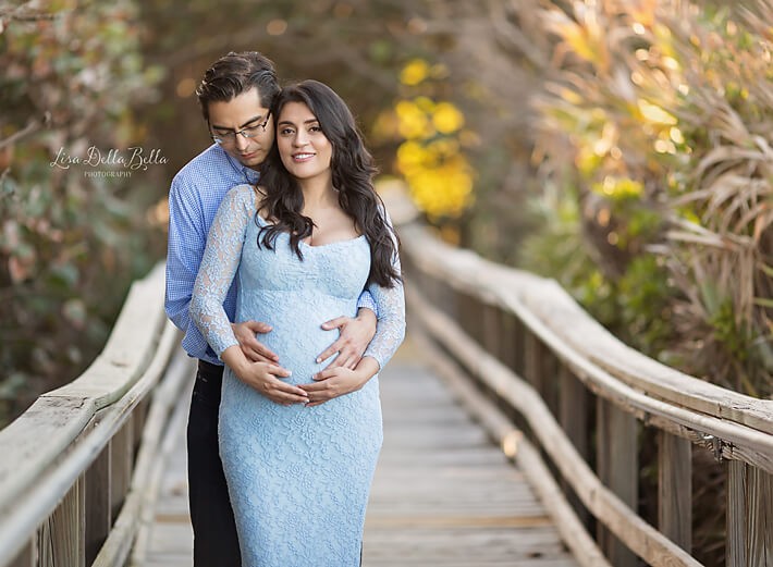 Maternity couple on boardwalk